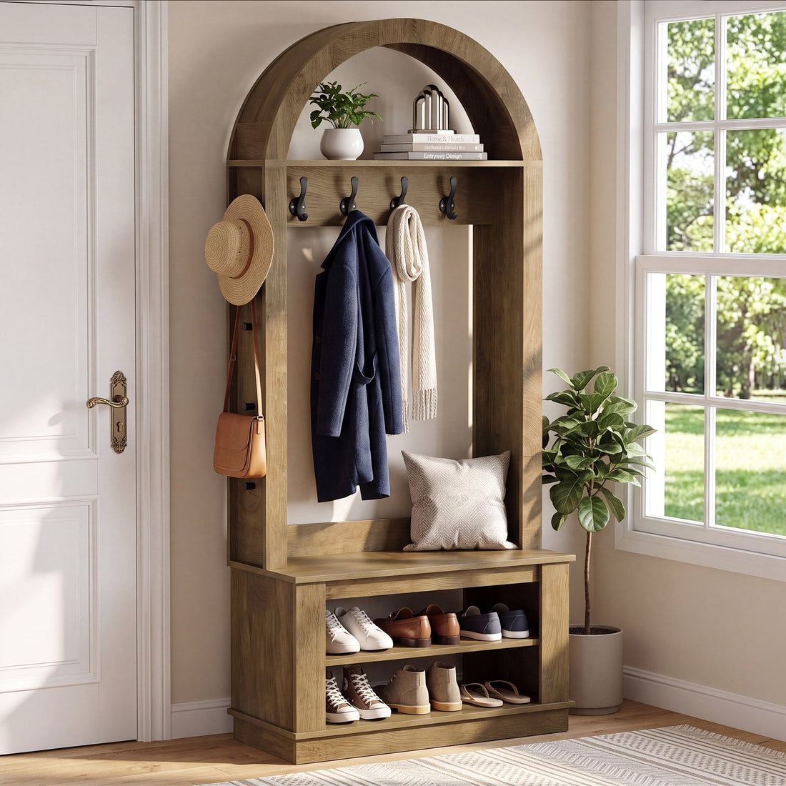 Stowena arched hall tree with bench, coats on hooks and shoes on the 2 tier rack by a window