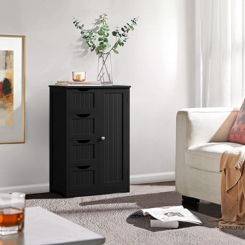 Black four drawer cabinet styled with a plant in a living room corner