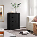 Black four drawer cabinet styled with a plant in a living room corner