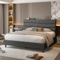 Grey upholstered full bed frame with storage headboard and phone charging at the shelf