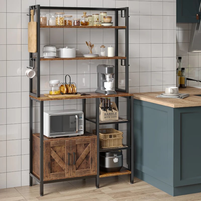 Bakers rack with cabinet in a kitchen holding a microwave, coffee maker, and jars