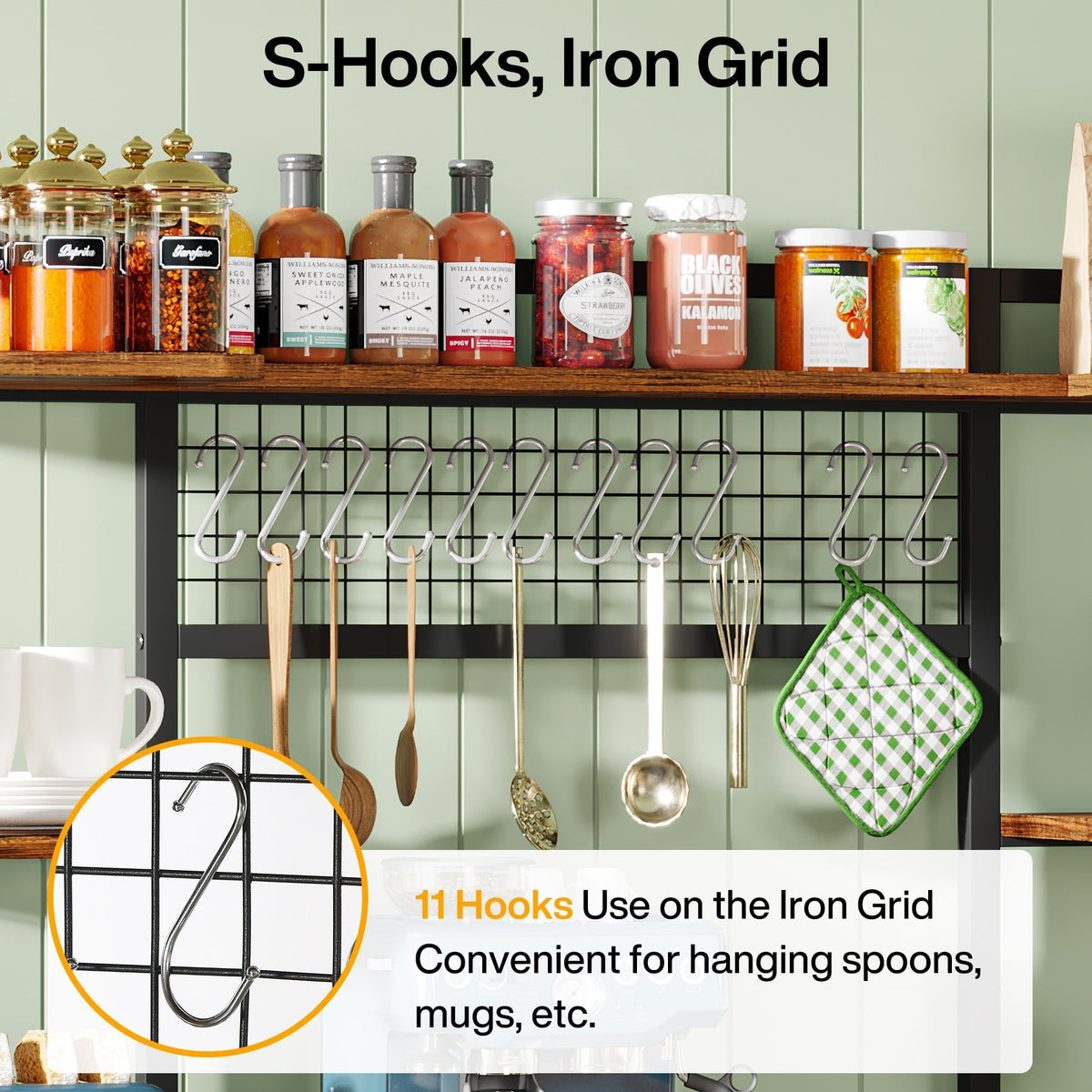 Close view of the iron grid panel with eleven S hooks holding mugs and utensils