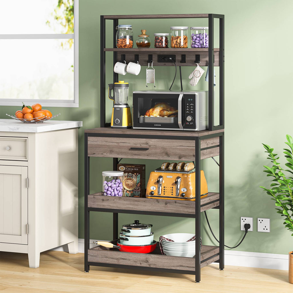 Bakers rack with microwave and dishes in a green kitchen corner