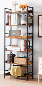 The bookshelf styled with books, a basket and a lamp, with eight S shaped hooks on the upright holding headphones, keys and a bag