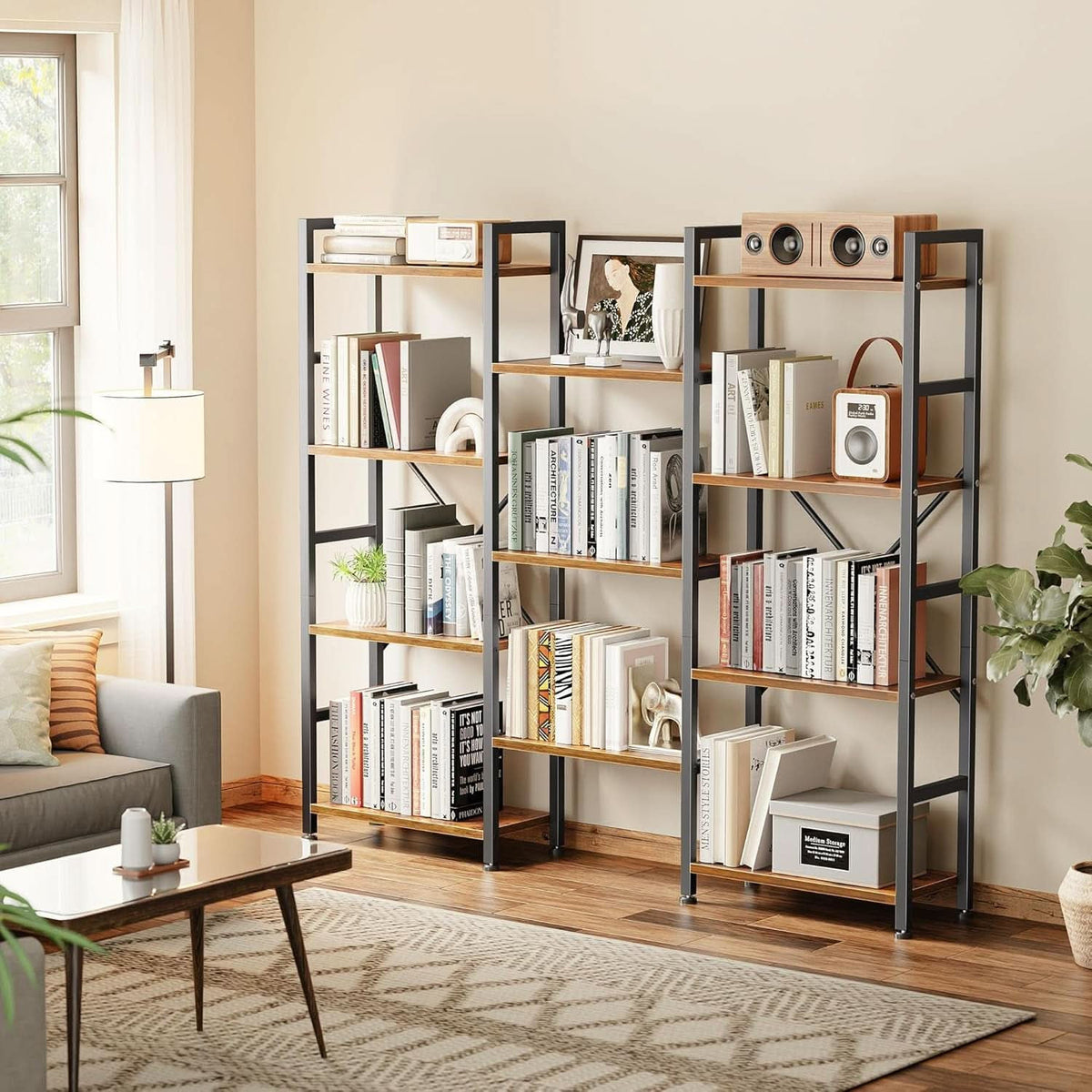Wide bookshelf holding books and decor beside a sofa in a living room