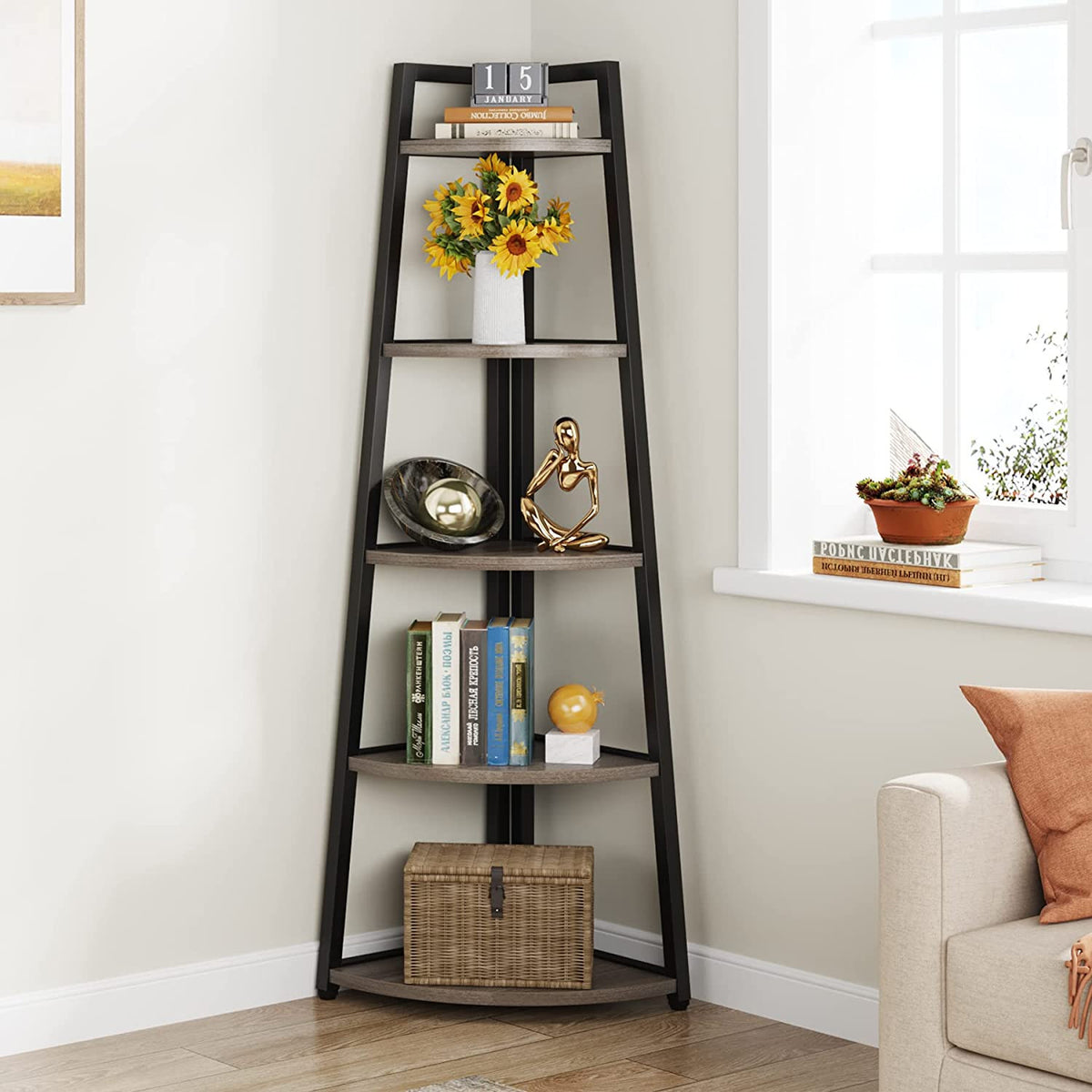 Tall corner bookshelf holding flowers, books and storage boxes