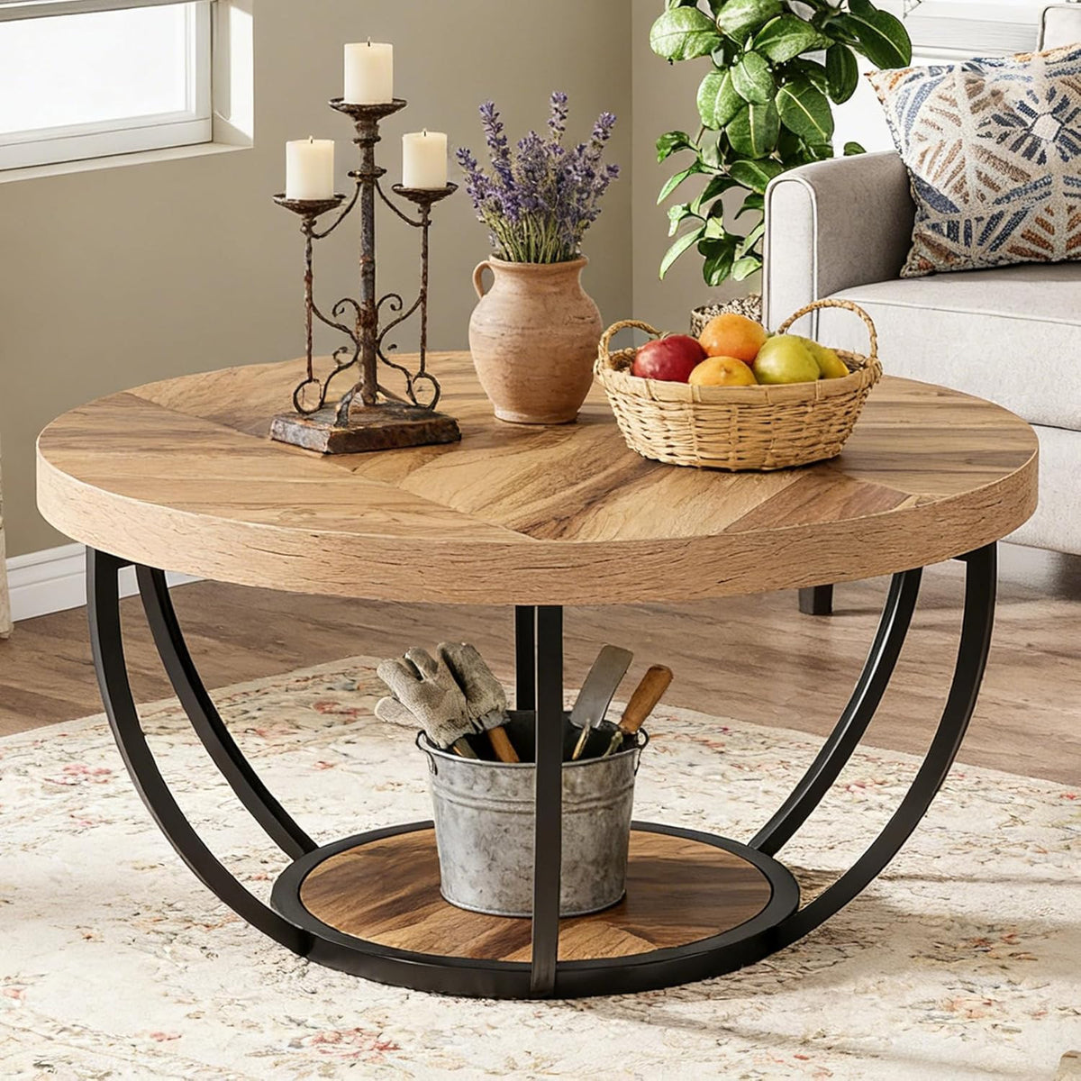 Stowena 31.7 inch round coffee table in wooden grain with candles and a fruit basket on top