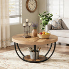 Round 2-tier coffee table styled in a living room with a plant and dishes