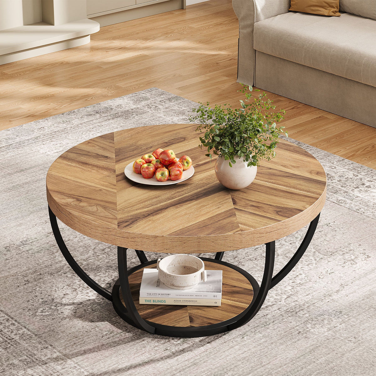 Wood grain round coffee table with a plate of food beside a gray sofa