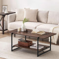 Stowena 41 inch industrial coffee table in walnut with a plant and books in front of a white sofa