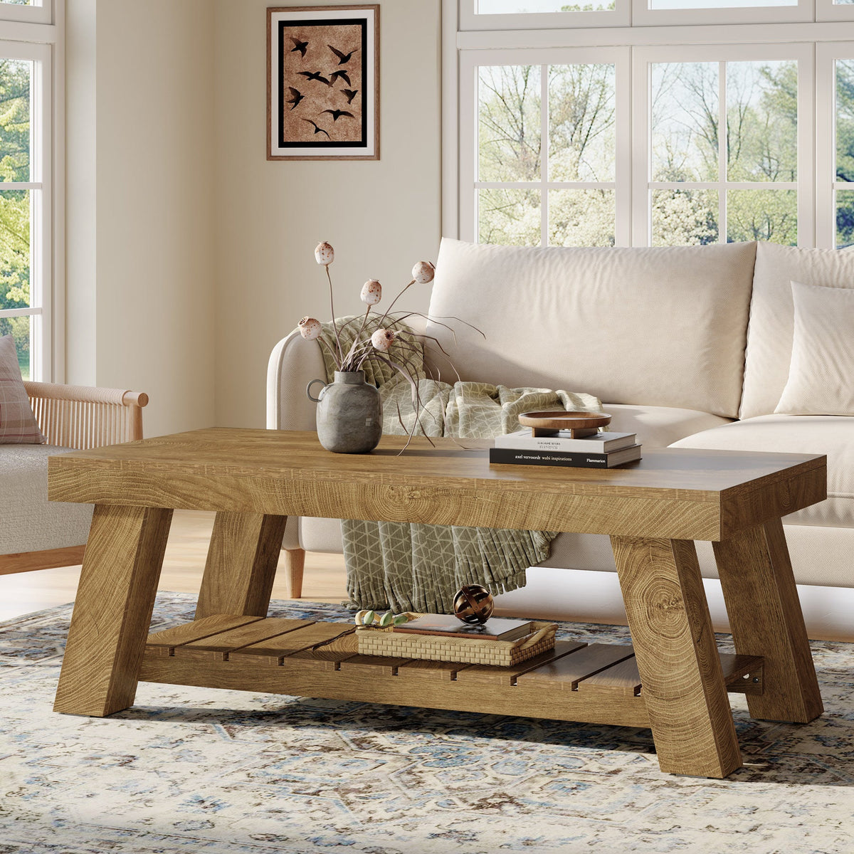 2 tier wood coffee table in front of a cream sofa holding a vase and books