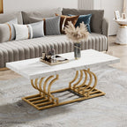 Stowena 47 inch faux marble coffee table with gold geometric base in front of a gray channel sofa