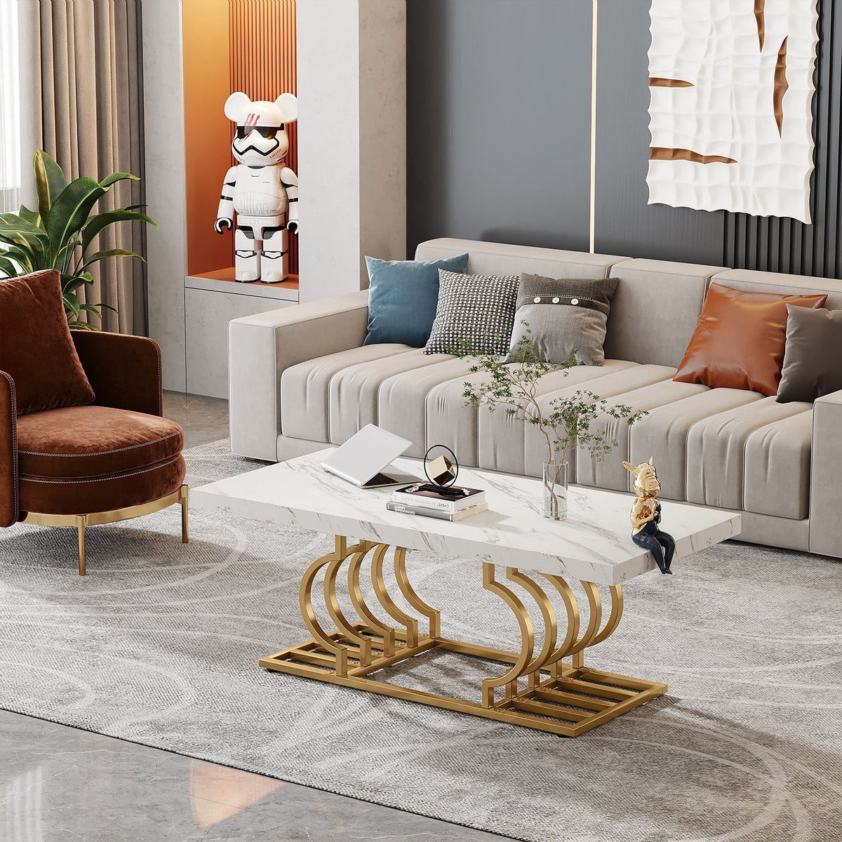White faux marble table with gold curved base in a modern living room with a green armchair