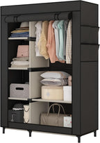 Black portable closet with the cover open, hanging shirts on the rod and folded clothes, boxes and a handbag across the six shelves