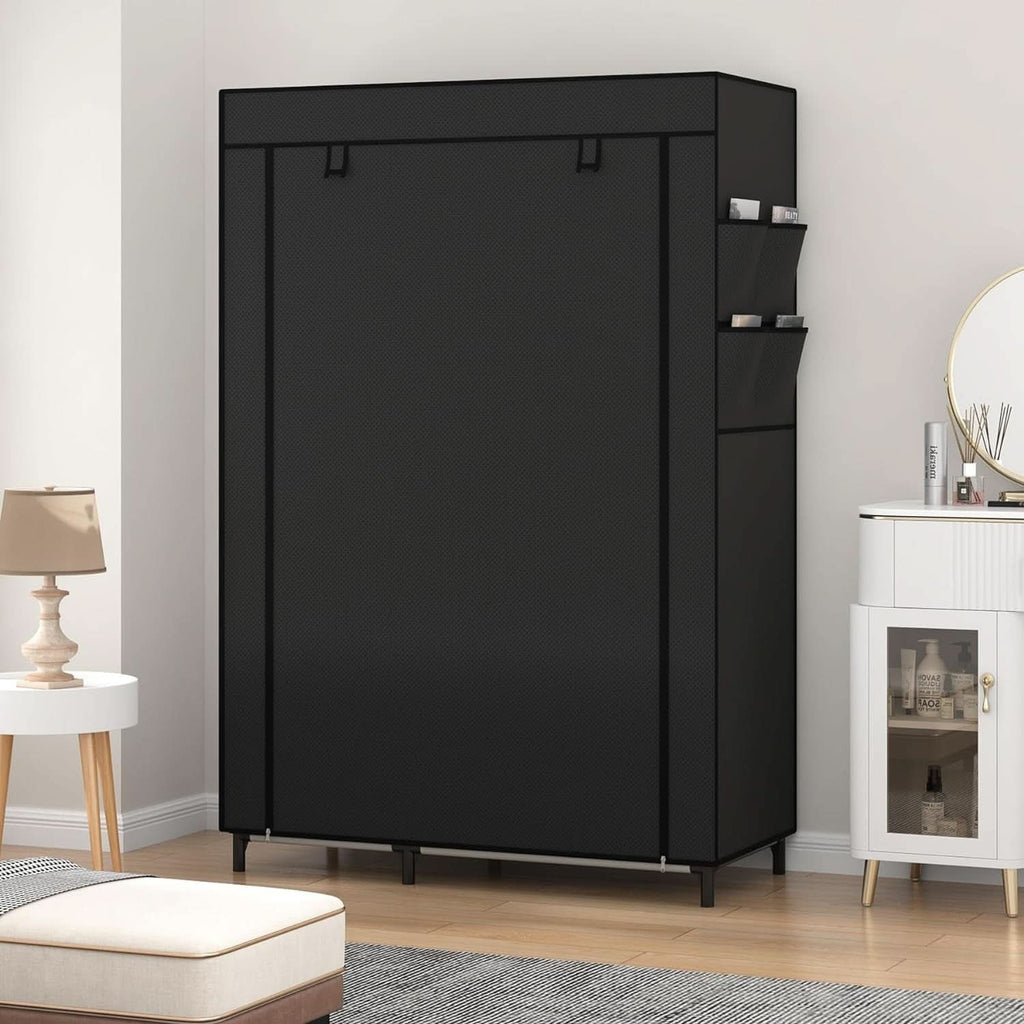 Black portable closet with the dust cover zipped shut in a bedroom, side pockets visible on the end panel