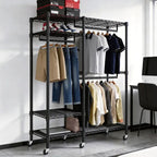 Black rolling clothes rack 45.5 x 16.6 x 79 in in a bedroom, hanging shirts and jeans on three rods with boxes and folded items on the wire shelves