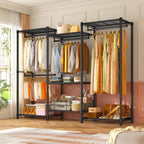 Black closet rack in a bedroom beside a curtained window, holding hanging clothes, folded stacks and a woven basket