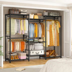 Black freestanding closet rack along a bedroom wall next to a bed, filled with hanging clothes, folded linens and storage boxes