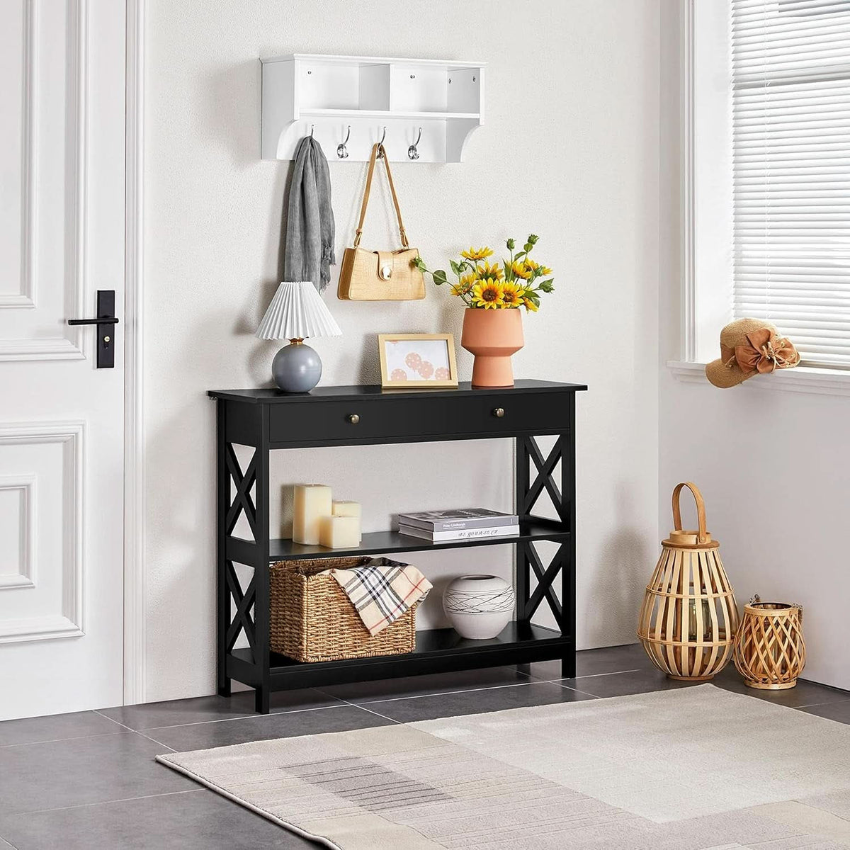 Black 3 tier console table under a wall shelf by a front door