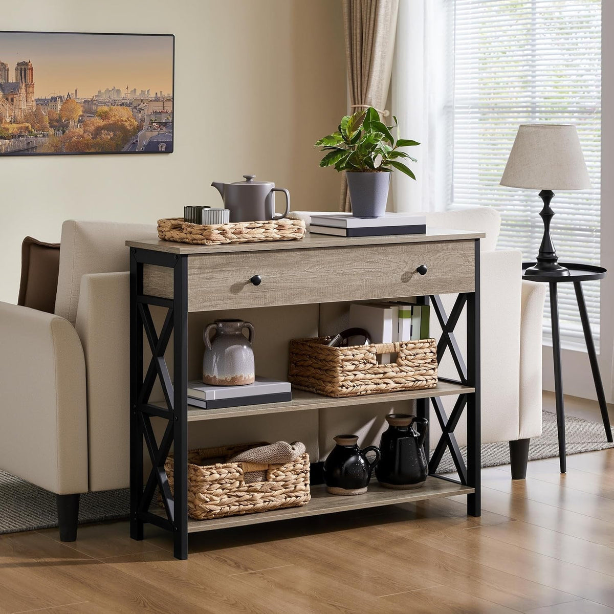 Gray sofa table with drawer behind a cream sofa holding a tea tray