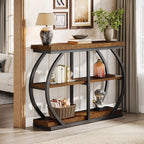 Console table in a living room with books and baskets stored on the middle tier