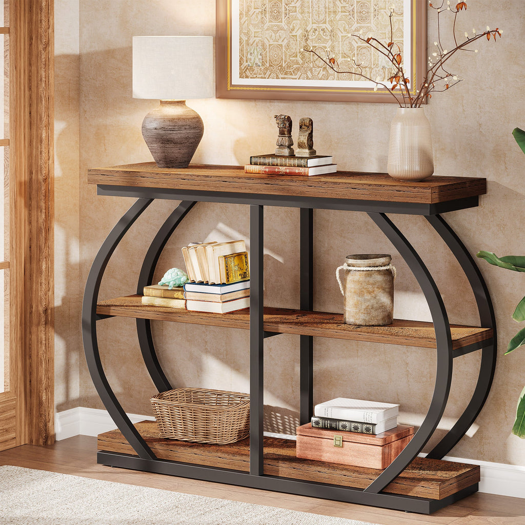 Brown console table styled with a lamp, books and pottery in a hallway