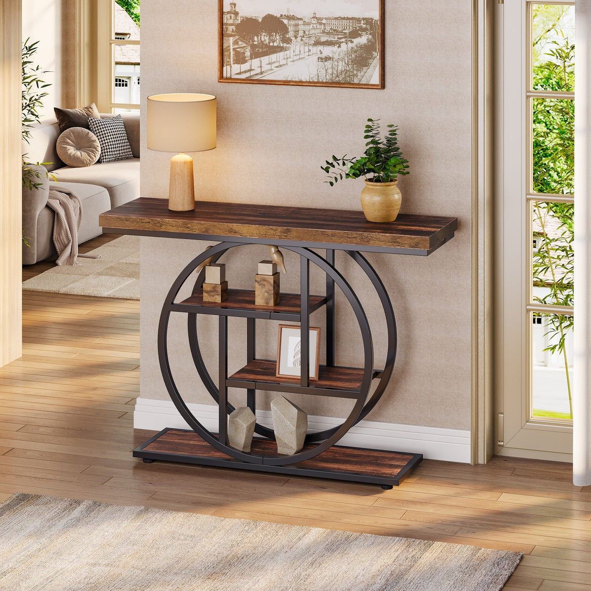 Rustic brown console table with interlocking circle base in an entry, lamp and plant on top