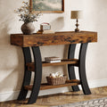 Stowena 41 inch curved console table in dark brown with black legs in an entryway