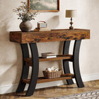 Stowena 41 inch curved console table in dark brown with black legs in an entryway