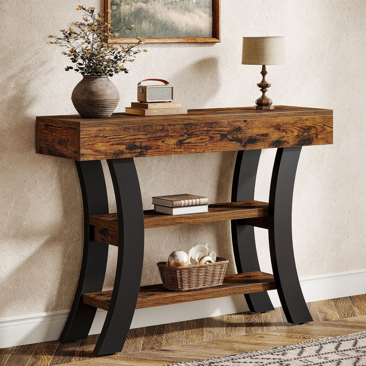 Stowena 41 inch curved console table in dark brown with black legs in an entryway