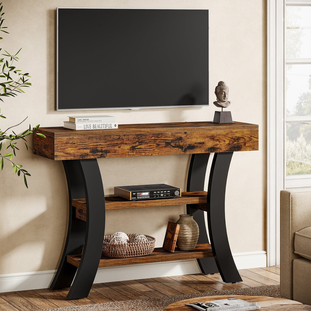Curved console table holding a TV with storage on both shelves
