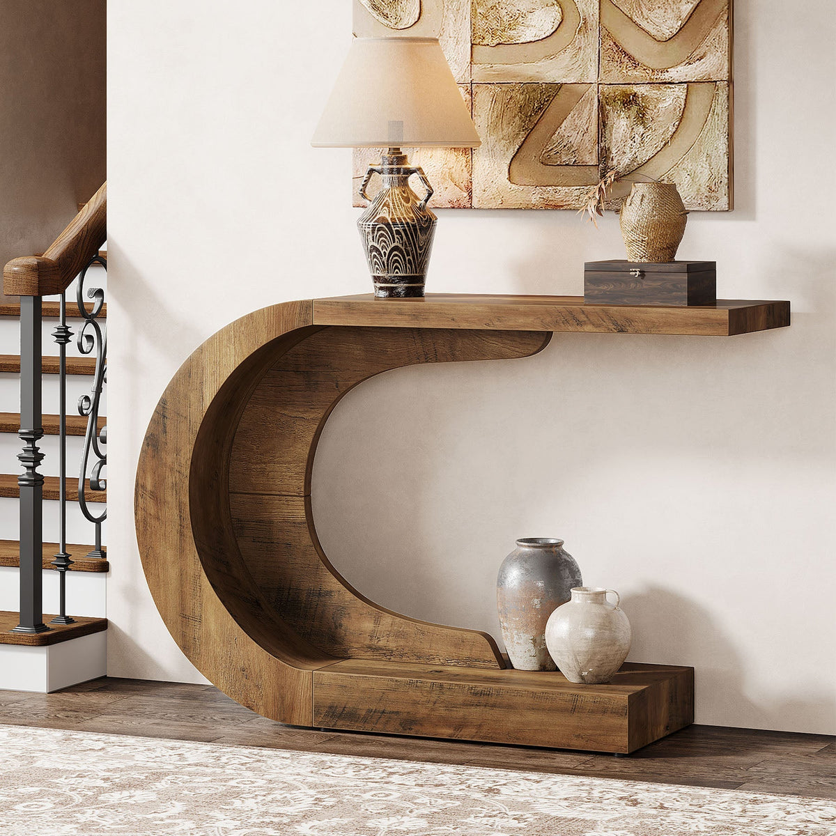 The C shaped console against a wall with pottery on the tabletop and a book on the lower arm