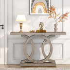 The long console against a panelled wall with a lamp, books and an ornament on top