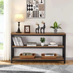 Rustic sofa table against a patterned wall with lamp and figures