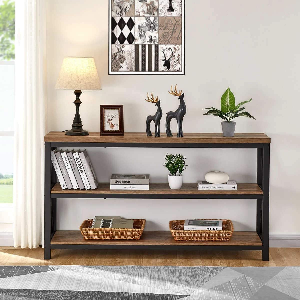 Rustic sofa table against a patterned wall with lamp and figures