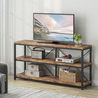 The console used as a TV stand with a television on top and media boxes on the shelves