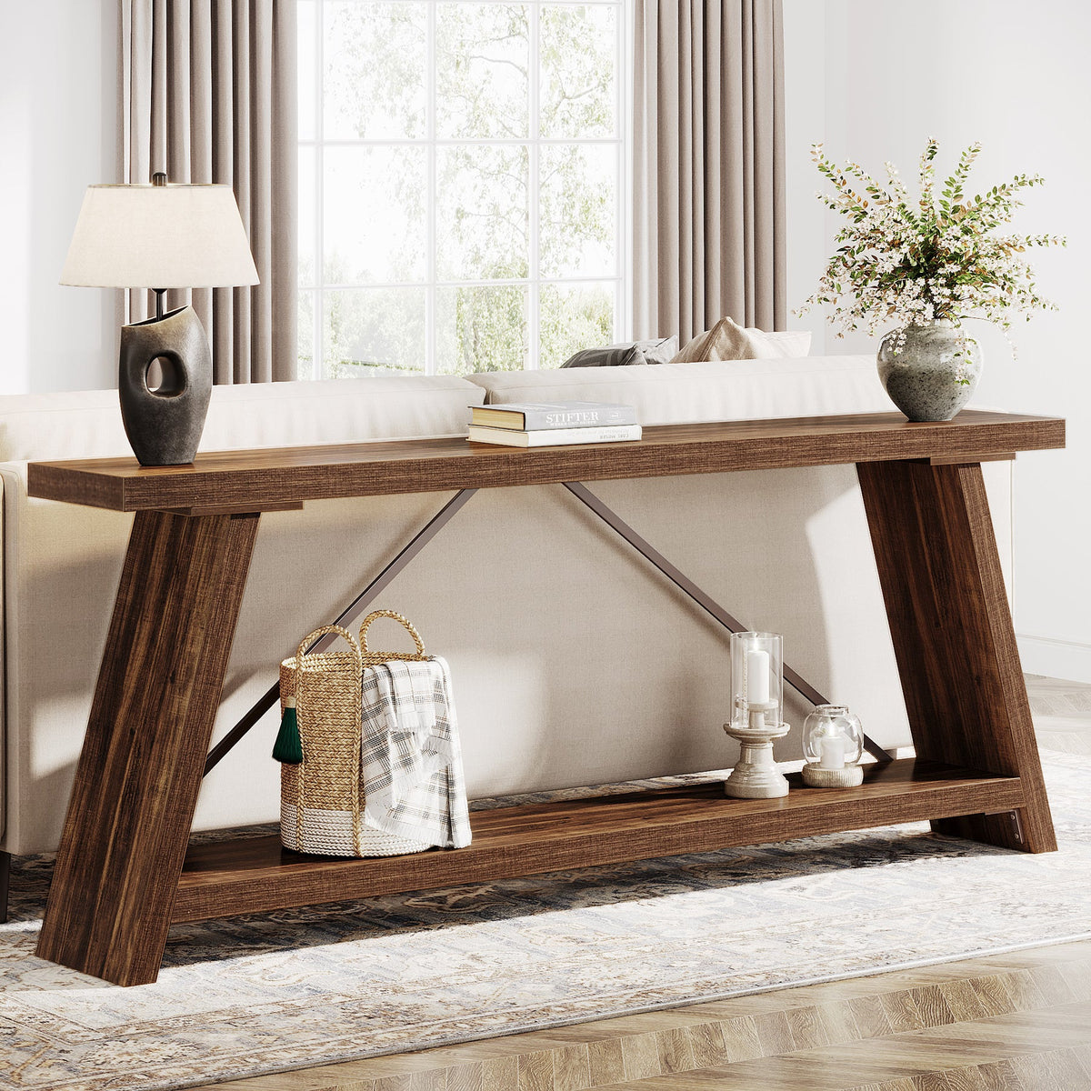 Extra long sofa table behind a couch holding a lamp and books