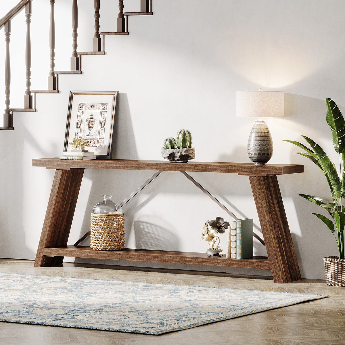 Long trestle console table styled by a staircase with a rug