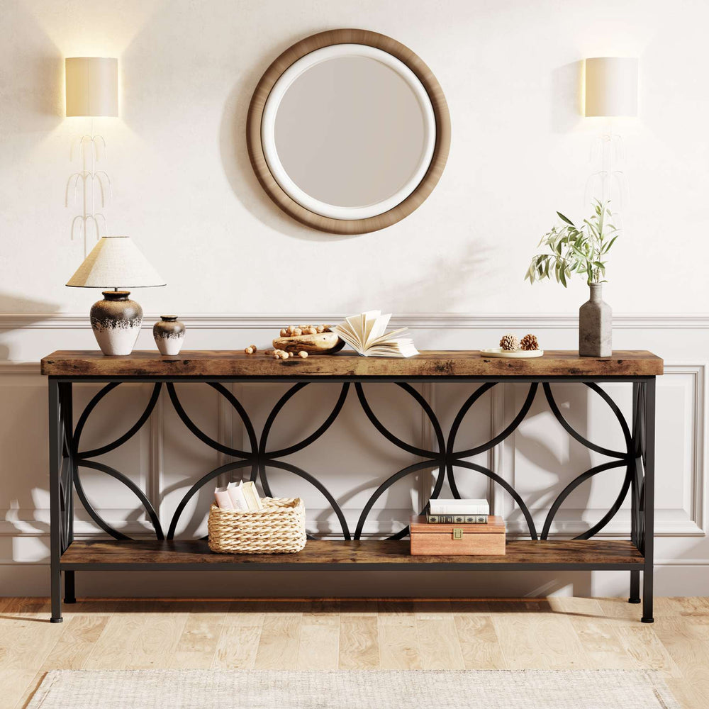 Industrial sofa table styled under a round mirror with lamps