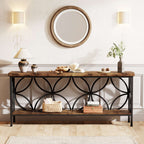 Industrial sofa table styled under a round mirror with lamps