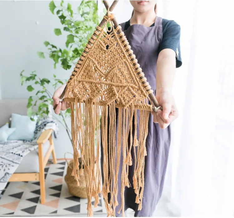 Macrame wall hanging held up to show full size, view 2