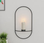 Black wall candle sconce holding a lit candle, view 2