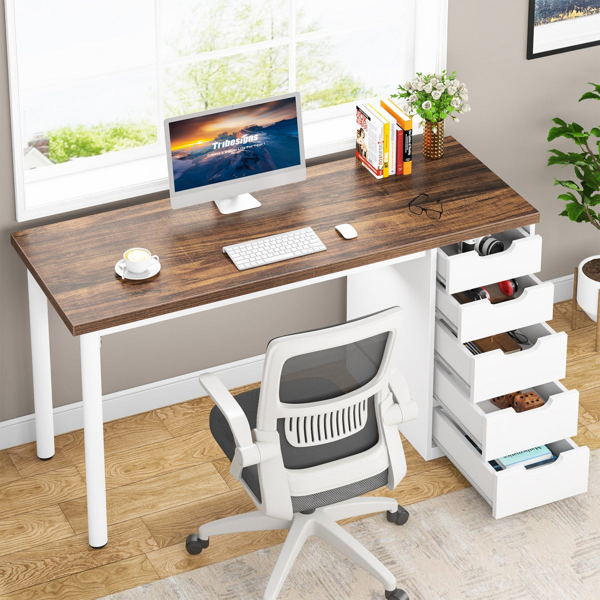 Computer desk with drawers open beside a window