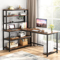 Brown L shaped desk with a hutch and mesh panel holding a monitor, books and plants