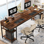 Rustic brown two person desk with two monitors raised on the full length riser and two chairs