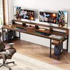 The desk set up with three screens on the riser and a games machine on the end shelf