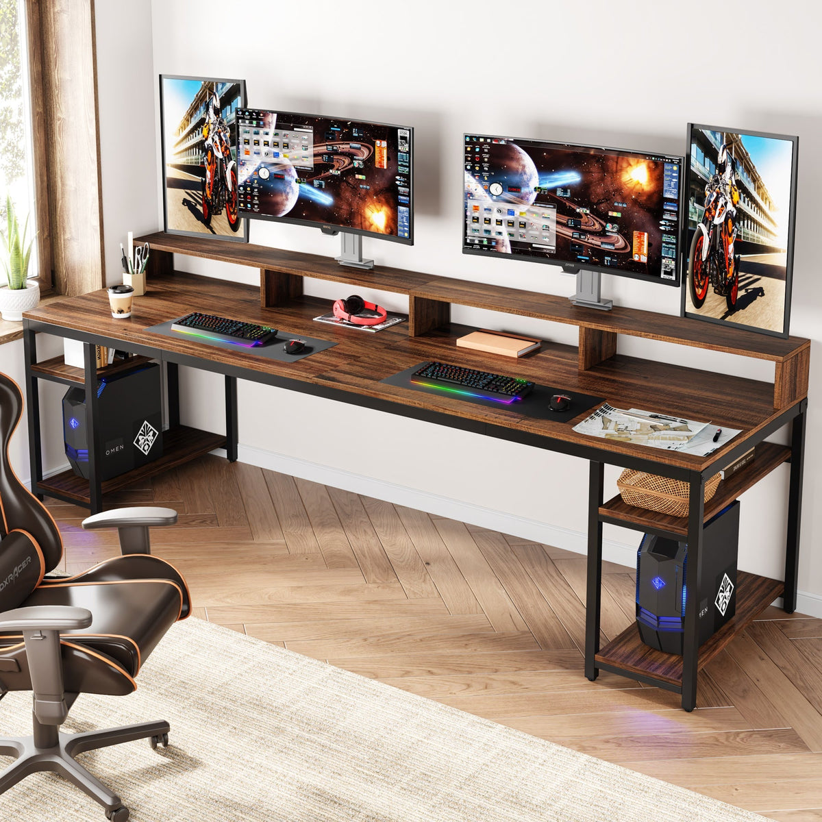 The desk set up with three screens on the riser and a games machine on the end shelf