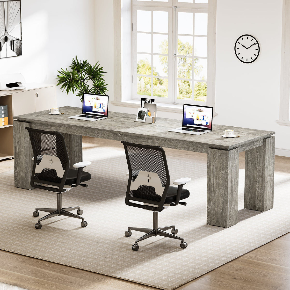 Two office chairs at the double desk with laptops and monitors