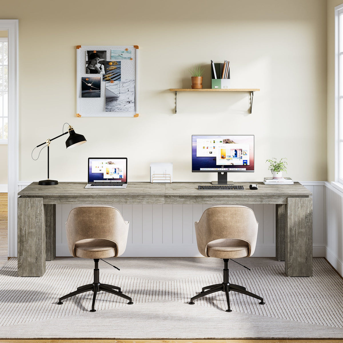Two person desk with lamp and pinboard wall in a home office