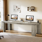 Dual workstation desk under wall shelves with monitors and decor